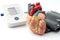 Anatomical Model of a Human Heart and Digital Blood Pressure Monitoring Device in Cardiology Doctor Office