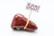 Anatomical shape of liver and gallbladder lies on white background with placard  inscripted SOS, asking doctor or patient for medi