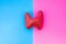 Anatomical shape of thyroid gland is located in middle of frame, divided by half by pink and blue background. Concept of gender fe