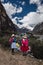 Ancash, Peru, July 29, 2014: three Peruvian women in traditional dress in the paron lagoon with snowy pyramid mountain