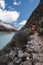 Ancash, Peru, July 29, 2014: two peruvian women in typical dress walking along a stone path in the turquoise lagoon of paron