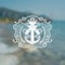 Anchor cross with two cannons in center of frame from line pattern and rope. Marine vintage label on sea blurred photo background