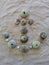 Anchor motive created with green sea urchins on beach sand