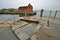 Anchor on seawall with fishing shack in the background