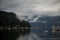 The anchor yacht in harbor near pier  After rain cloudy sky, misty forest mountains and calm water.