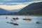 Anchored boats in Loch Broom off the harbor of Ullapool, Scotland, glow in the light from a sunset