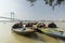 Anchored floating boats on river Hoogly with Vidyasagar Setu or 2nd Hoogly bridge in background