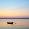 Anchored rowboat at sunset