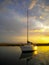 Anchored sailboat at sunset