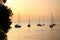 Anchored sailboats at sunset