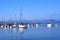 Anchored sailing boats in the blue calm water