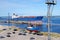 Anchored ships in the sea port in Ventspils, Latvia beside the coastline with parked cars