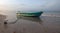 Anchored small fishing boat at sunset on Nilaveli beach in Trincomalee Sri Lanka