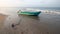 Anchored small fishing boat at sunset on Nilaveli beach in Trincomalee Sri Lanka