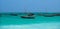 Anchored Traditional wooden dhow boats on the amazing turquoise water in the Indian ocean at Nungwi village, Zanzibar