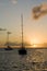 Anchoring ships in tropical bay at sunset. Small yachts and catamarans on sea water during dusk. Santa Lucia.