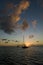 Anchoring ships in tropical bay at sunset. Small yachts and catamarans on sea water during dusk. Santa Lucia.