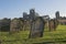 Ancient abbey ruins with gothic architecture and cemetary in rural landscape