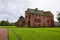 Ancient Abbots House building at courtyard of Arbroath Abbey in Scotland at cloudy afternoon