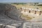 Ancient antique amphitheater in city of Hierapolis in Turkey. Steps and antique statues with columns in the amphitheater