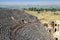 Ancient antique amphitheater in city of Hierapolis in Turkey. Steps and antique statues with columns in the amphitheater