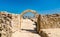 Ancient arch at Bahrain Fort with skyline of Manama. A UNESCO World Heritage Site