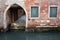 Ancient archway above backwater of Venice
