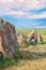 The ancient astrologica observatory Karahunj in Armenia. `Armenian Stonehenge`. A view of the horizon and a blue bright sky.