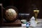 Ancient astrology. Old astrology globe and books with candle