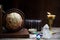 Ancient astrology. Old astrology globe and books with lighting candle