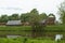 Ancient authentic wooden houses in Belarus, a cloudy day, calm river in landscape