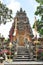 Ancient Balinese temple with carved stone details and colorful banners in Bali Indonesia