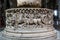 Ancient baptismal font in the interior of the Basilica of San Frediano, Lucca, Italy