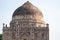 Ancient Bara Gumbad Tomb Lodi Gardens New Delhi India, tomb dome showing against a blue sky