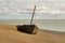 Ancient boat on the ocean coast. Puerto Santa Cruz