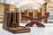 Ancient books with a magnifying glass and a antique wooden candle holder on a bright table isolated over abstract blurred library