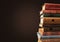 Ancient books in a row on wooden background