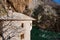 Ancient brick building of historical Sufi monastery Blagaj Tekke with a river and the mountains around