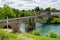 Ancient bridge over the river Gave d`Oloron at town of Navarrenx, France