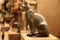 ancient bronze statue of goddess Bastet as a cat from old Egypt. Side view.