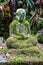 Ancient Buddha Statue in Green Moss in a forest