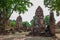 Ancient Buddha Statue,Khmer-style prangs and ruins at Wat Mahathat,Phra Nakorn Sri Ayutthaya,Thailand.A UNESCO World Heritage Site