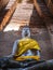 Ancient Buddha statue in ruined Buddhist temple