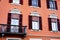 Ancient building with stucco on the windows and shutters. Menaggio, Como, Italy