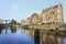 Ancient buildings and a canal in Amsterdam historical center at daybreak, Netherlands