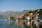 Ancient buildings with red roofs on the Perast coast. Montenegro