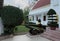 Ancient cannon and sculpture of lion, near the steps of the house. Beautifully trimmed bushes. Garden sculpture