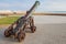 Ancient cannon stands on the beach in Tangier