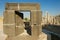 Ancient carved Basalt Door at the Citadel of Amman with ruined columns in Amman, Jordan.