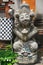 Ancient carved stone guardian statue with painted features outside a temple in Bali Indonesia